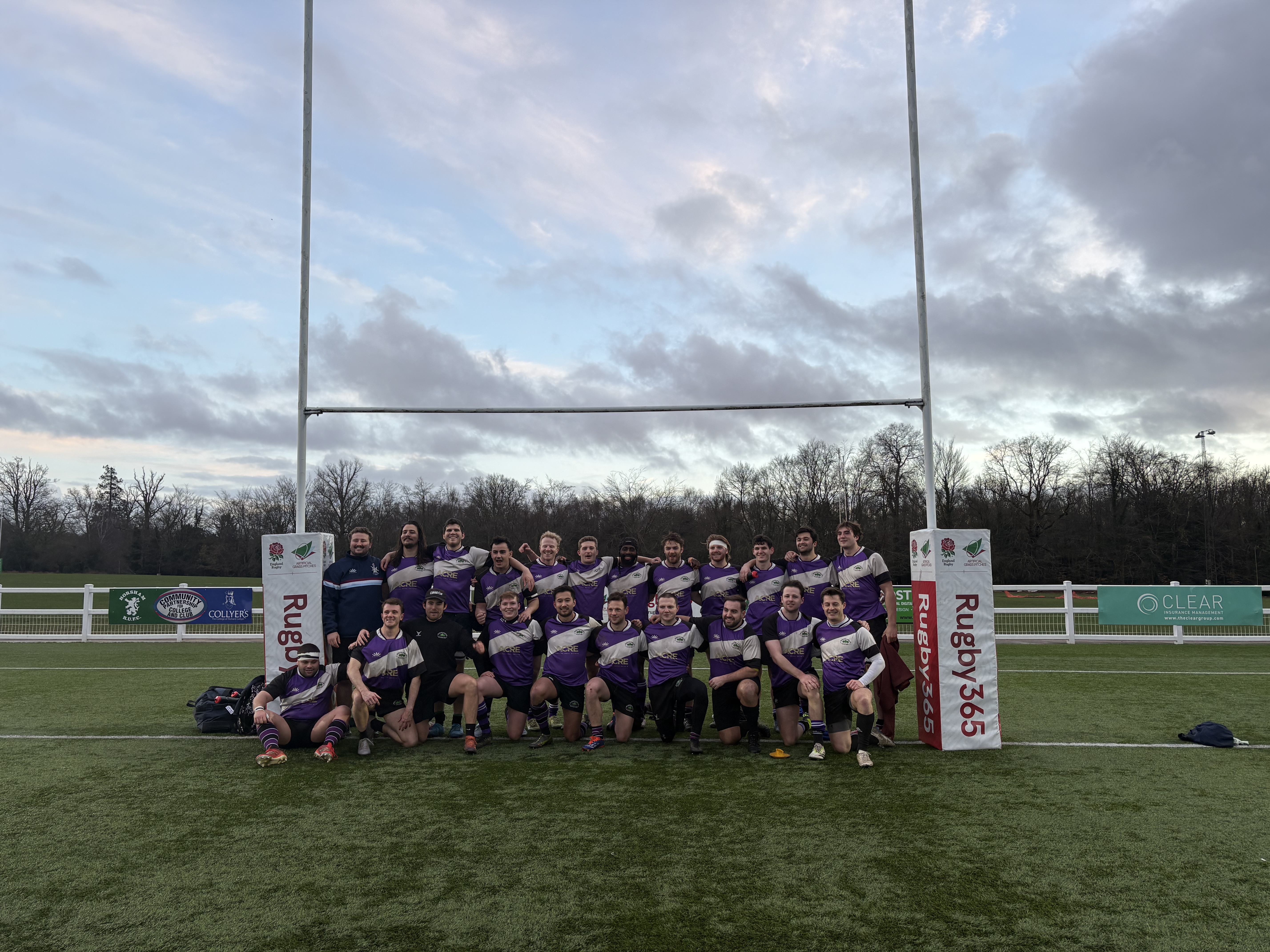A club side lined up under the posts after a match